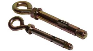 The anchor bolt with ring is protected by a white or yellow anti-corrosion coating