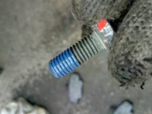 A bolt with a blue locking agent applied to its threads