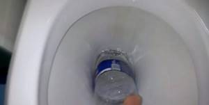 cleaning the toilet with a plastic bottle