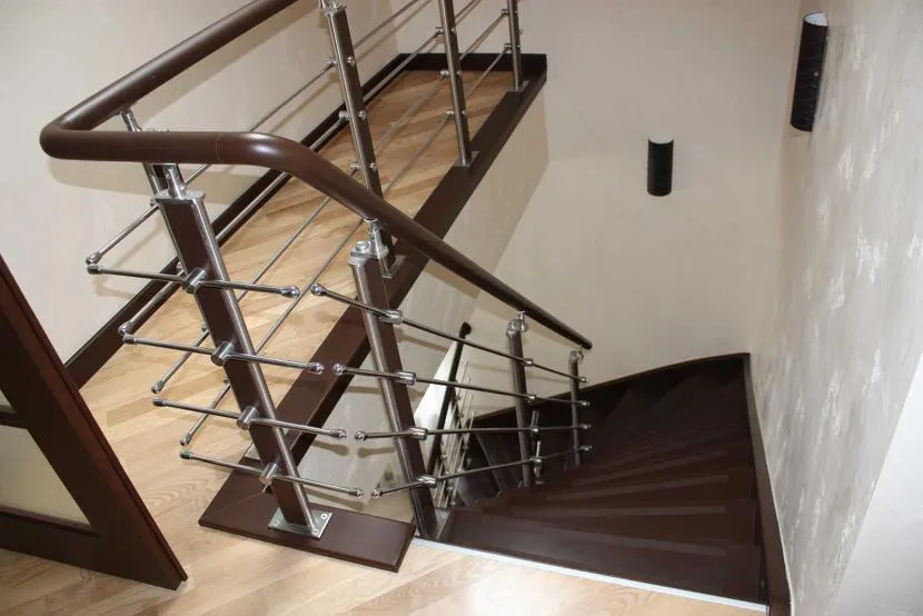Wooden staircase with metal railing and PVC handrails