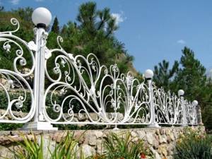 Forged fence on a rubble stone foundation