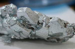 A soft, brittle silver-white metal with a bluish tint - gallium