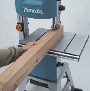 Working on a wood band saw