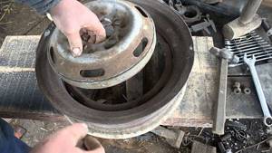 working on a furnace made from wheel rims