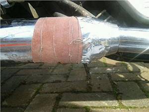Repairing a muffler using a ceramic tape bandage