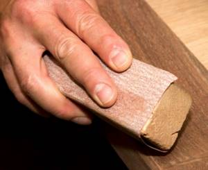 Sanding wood with sandpaper