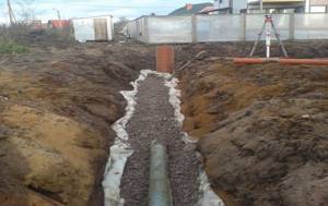 laying a drainage pipe in a ditch