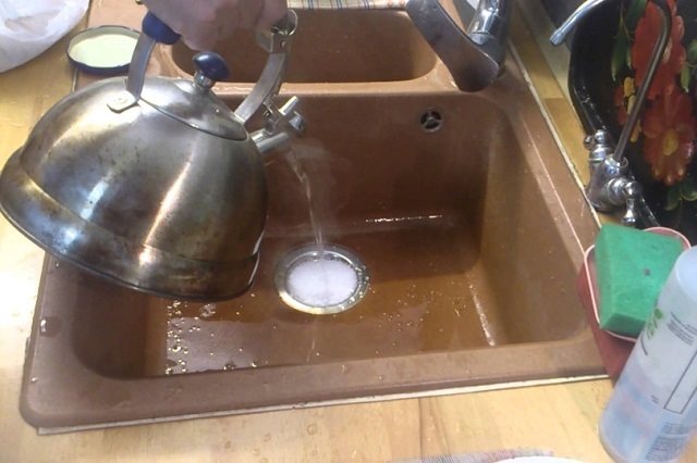 Pouring boiling water into the drain after the “work” of soda and vinegar.