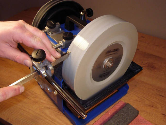 sharpening a cutter on a grinding wheel